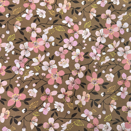 Cherry blossom patterned wrapping paper in pink, white and yellow on brown background