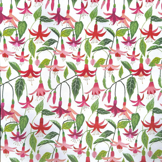 a sheet of wrapping paper with stylised pink fuchsia flowers, green leaves on a white background