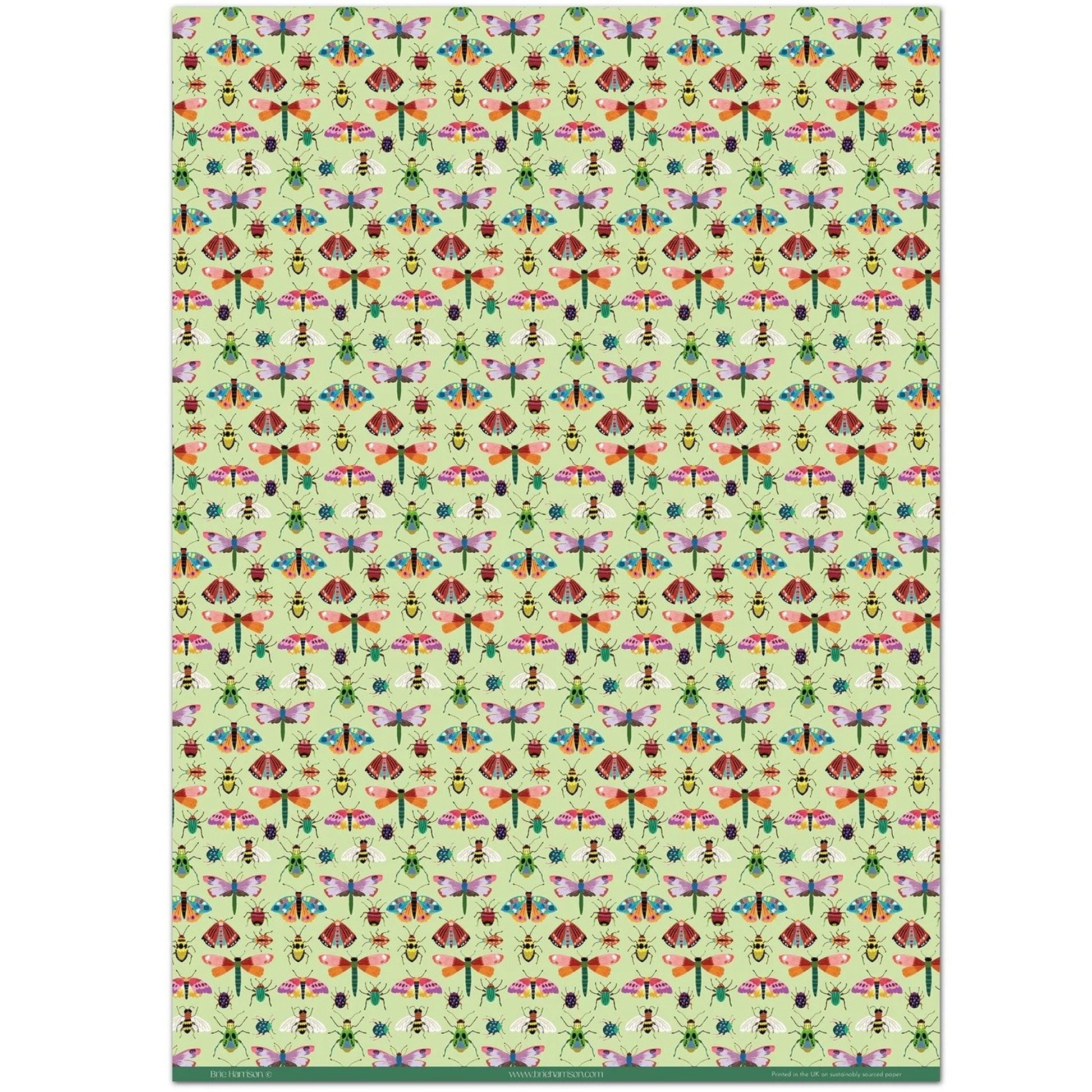 A sheet of wrapping paper with a pattern of colourful butterflies and insects on a light green background