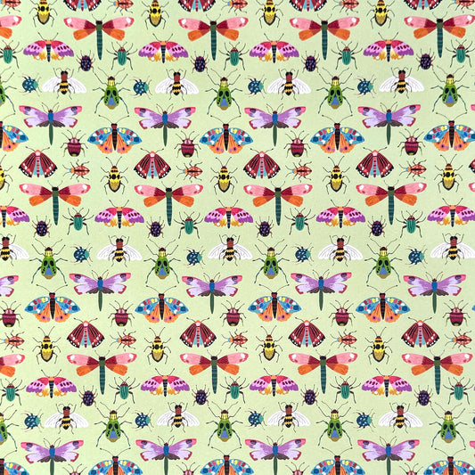 A sheet of wrapping paper with a pattern of colourful butterflies and insects on a light green background