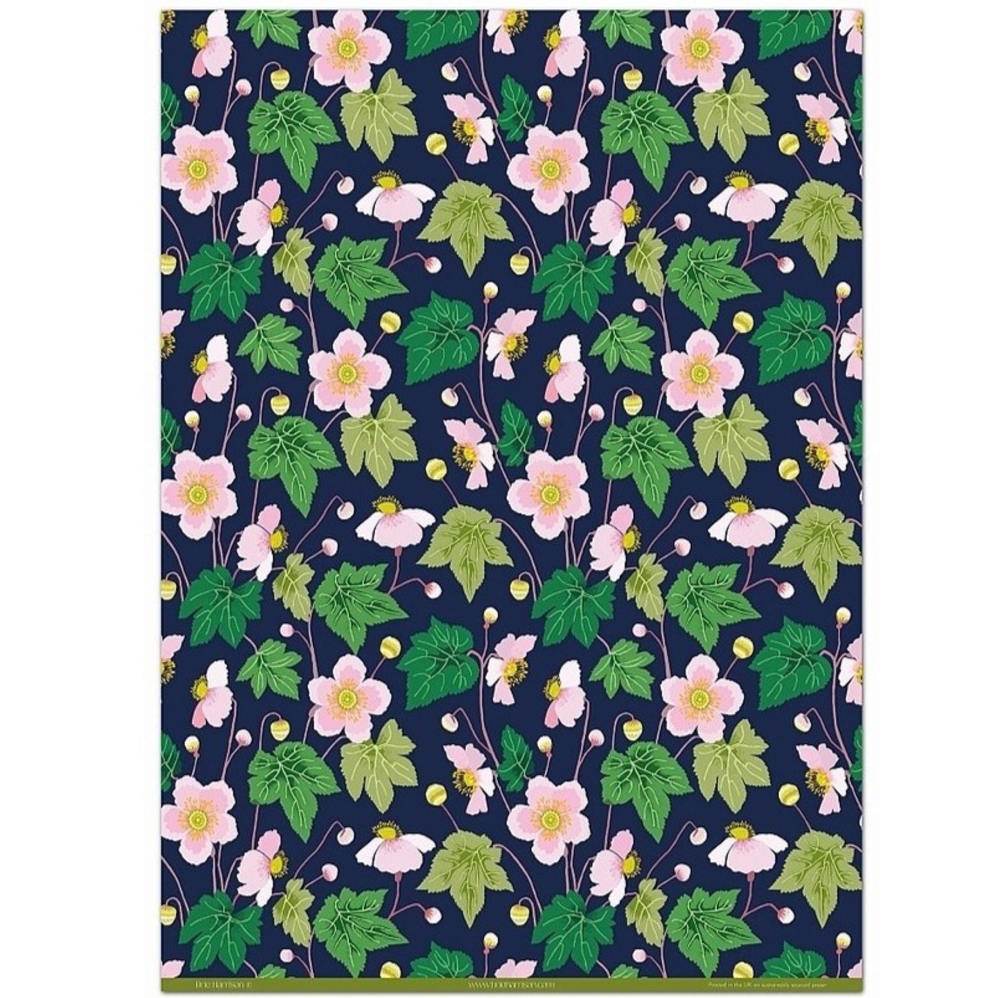 a sheet of wrapping paper with a dark indigo background and pink japanese anemone flowers and green foliage