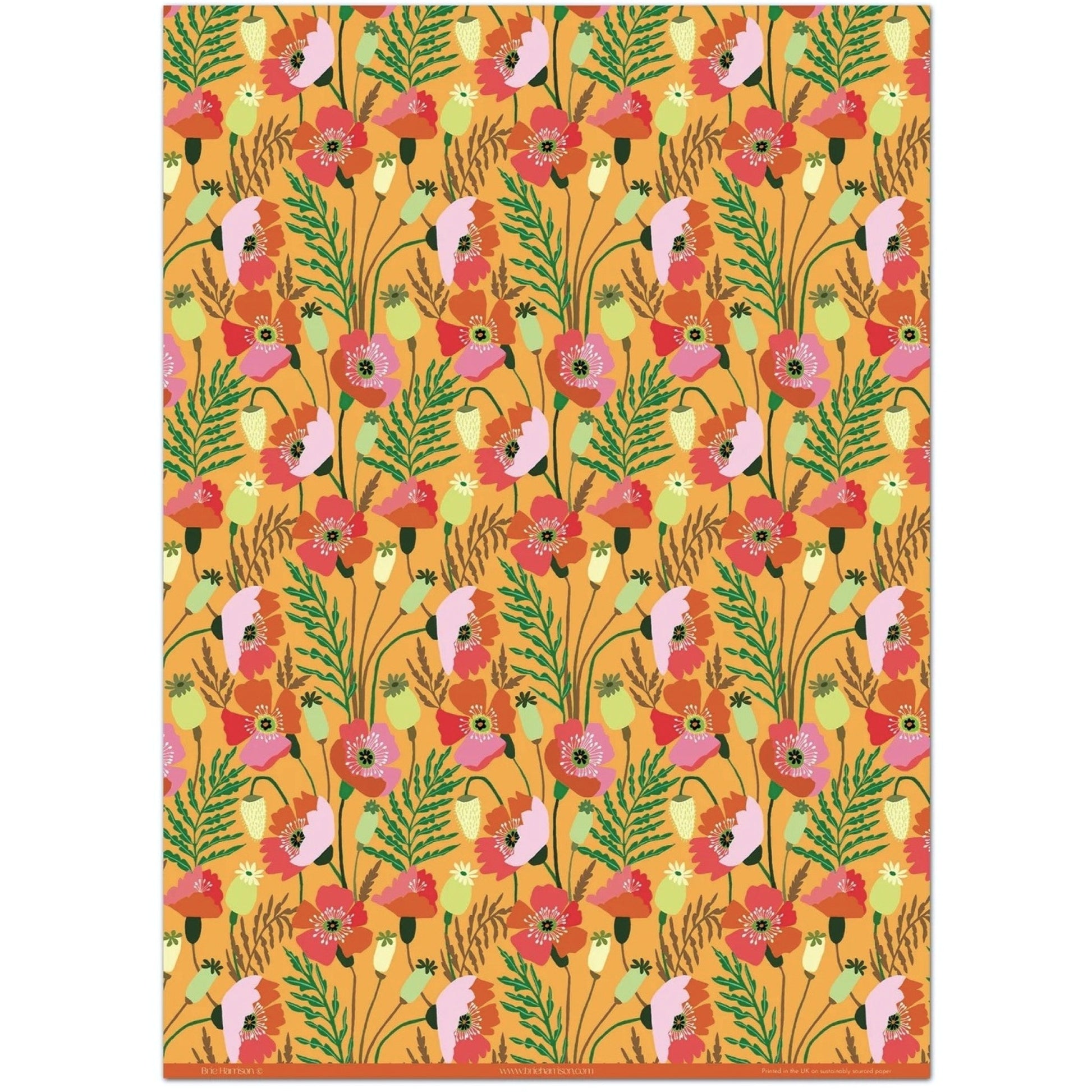a sheet of wrapping paper with a pattern of stylised pink poppies with green foliage on an orange background
