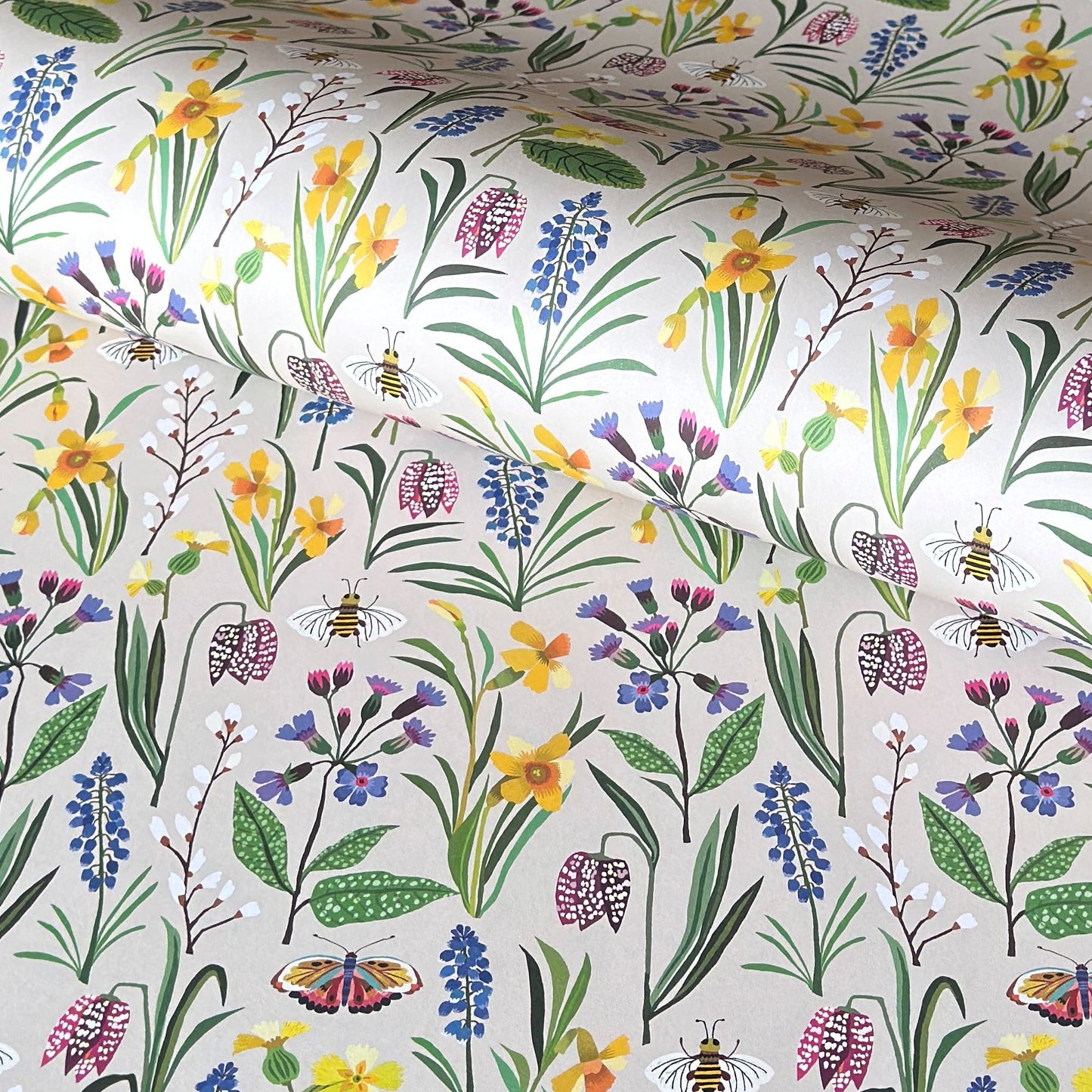 Patterned paper with colourful spring flowers and bees on a ivory background