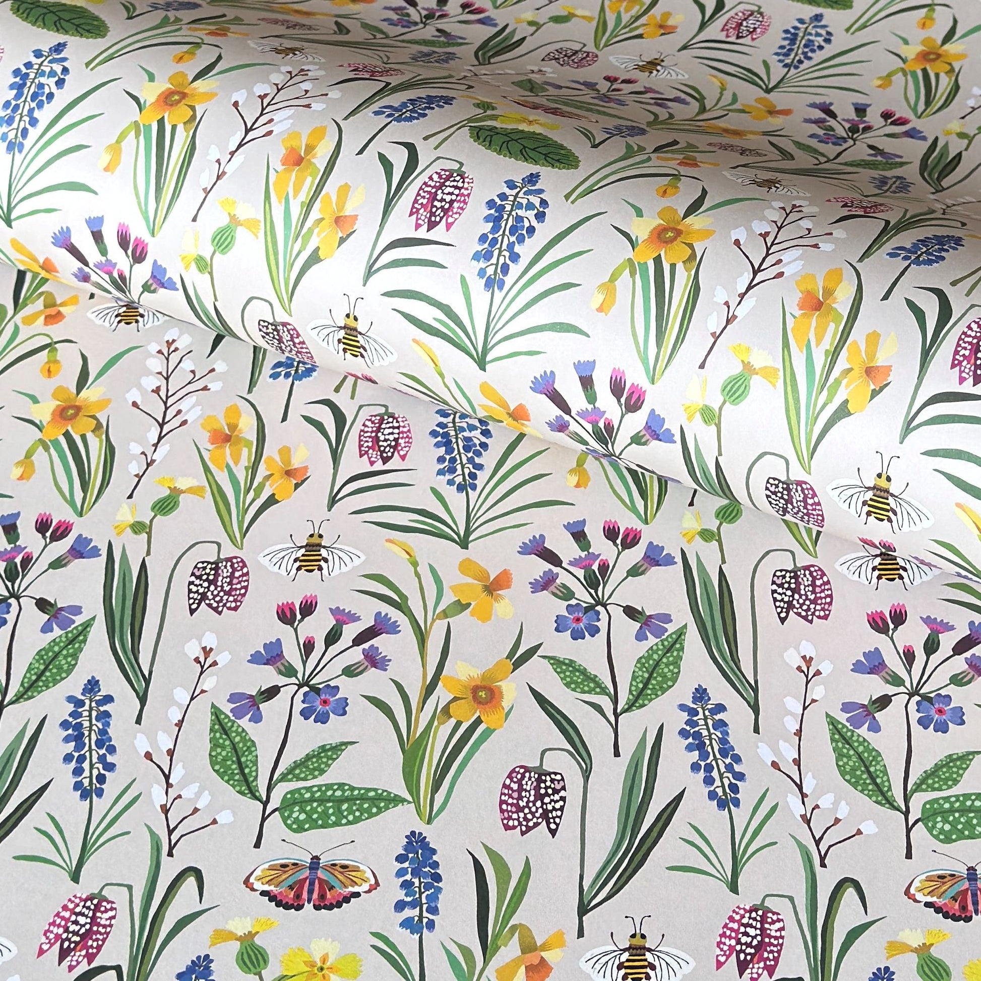 Patterned paper with colourful spring flowers and bees on a ivory background