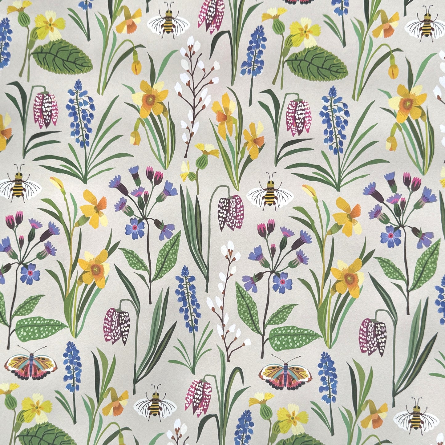Patterned paper with colourful spring flowers and bees on a ivory background