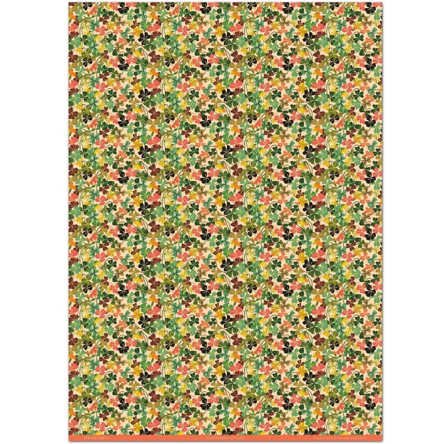 a sheet of wrapping paper with a stylised pattern of wood sorrel flowers in palette of pink, green and mustard