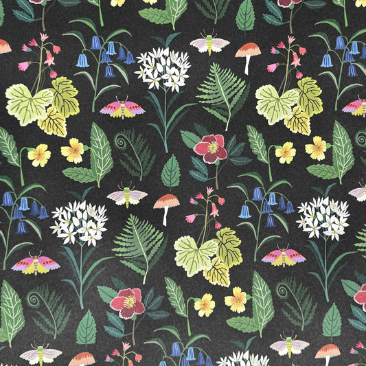  a sheet of wrapping paper with a black background and multl-colour flowers and fauna  from a woodland in bright colours