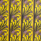 wrapping paper with a stylised pattern of lilac irises on a yellow background