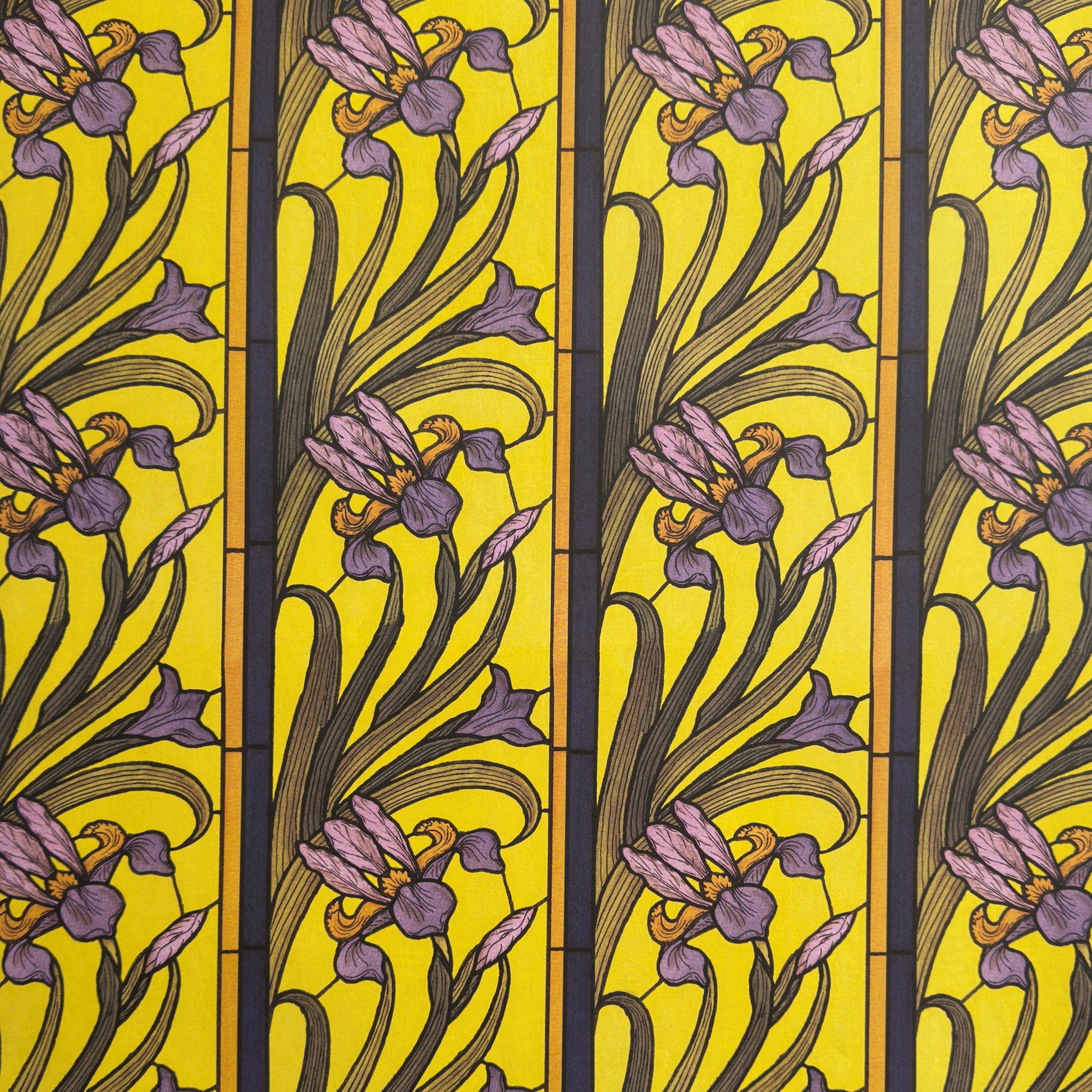 wrapping paper with a stylised pattern of lilac irises on a yellow background