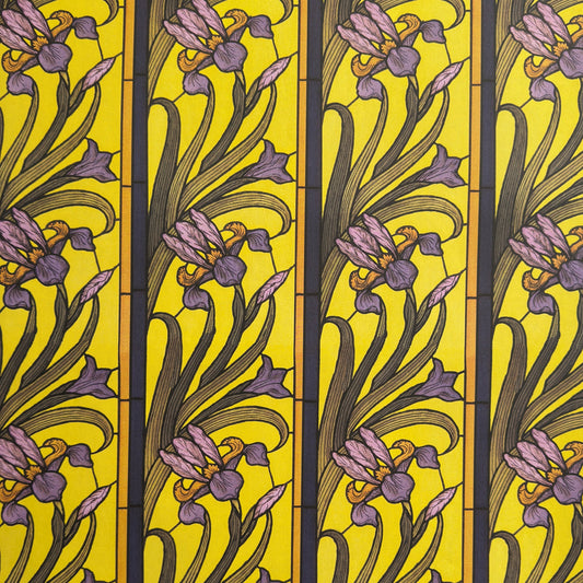 wrapping paper with a stylised pattern of lilac irises on a yellow background