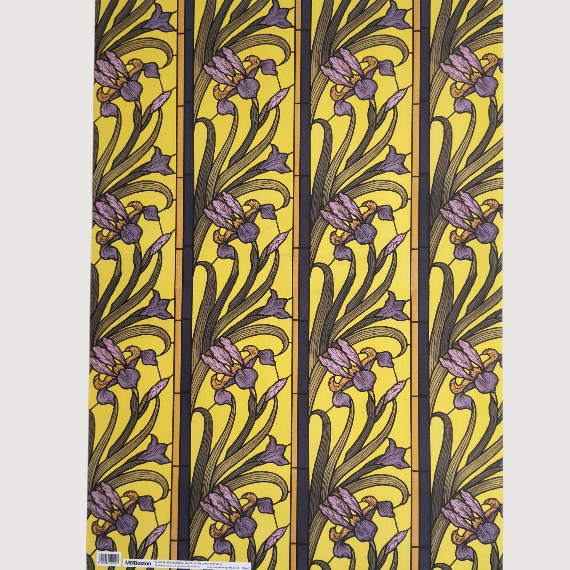 wrapping paper with a stylised pattern of lilac irises on a yellow background. Full sheet pictured