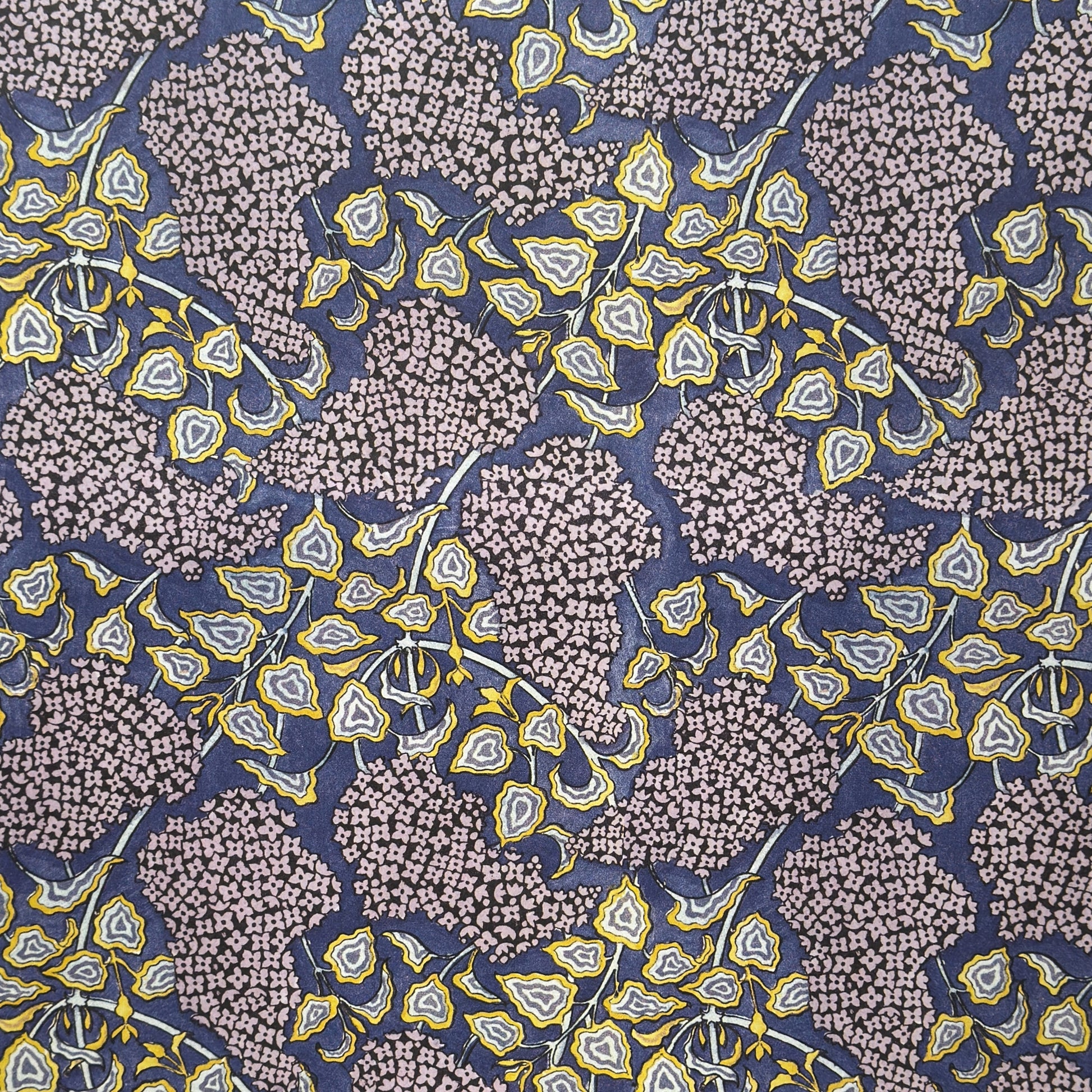 wrapping paper with a stylised lilac flower pattern in lilac , yellow and white