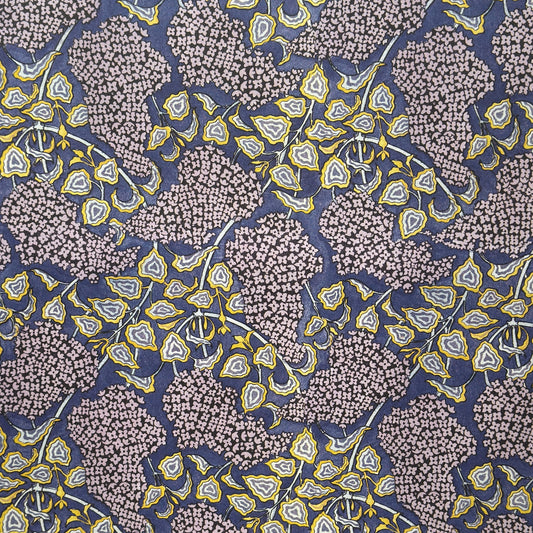 wrapping paper with a stylised lilac flower pattern in lilac , yellow and white