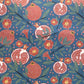 Pattern of pomegranates and flowers on a blue background- sheet of wrapping paper