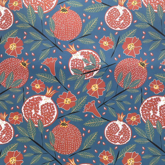 Pattern of pomegranates and flowers on a blue background- sheet of wrapping paper