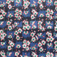 wrapping paper with a red and white flower pattern on two-toned blue background