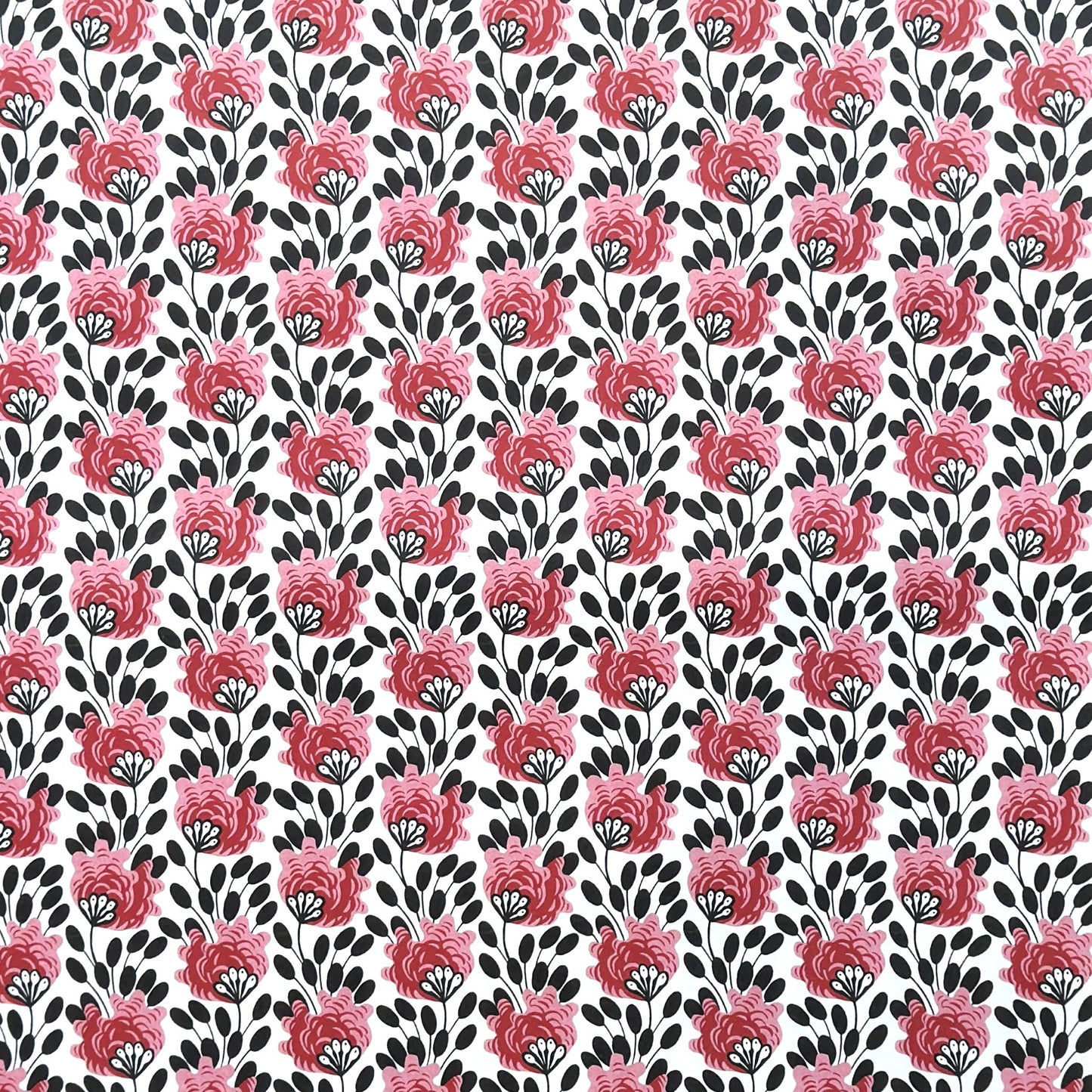 wrapping paper with a repeat design of pink flowers, black seedheads on white 