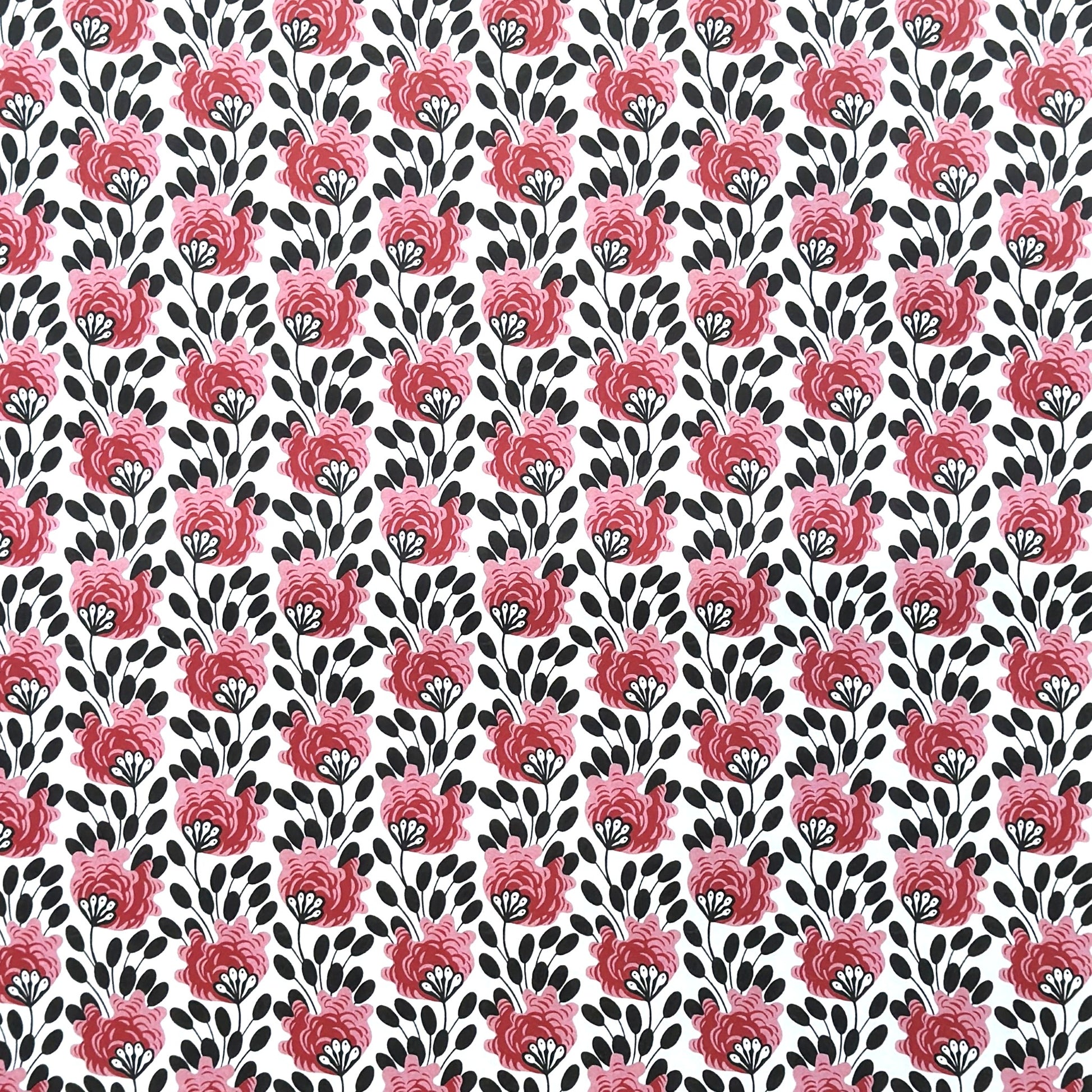 wrapping paper with a repeat design of pink flowers, black seedheads on white 