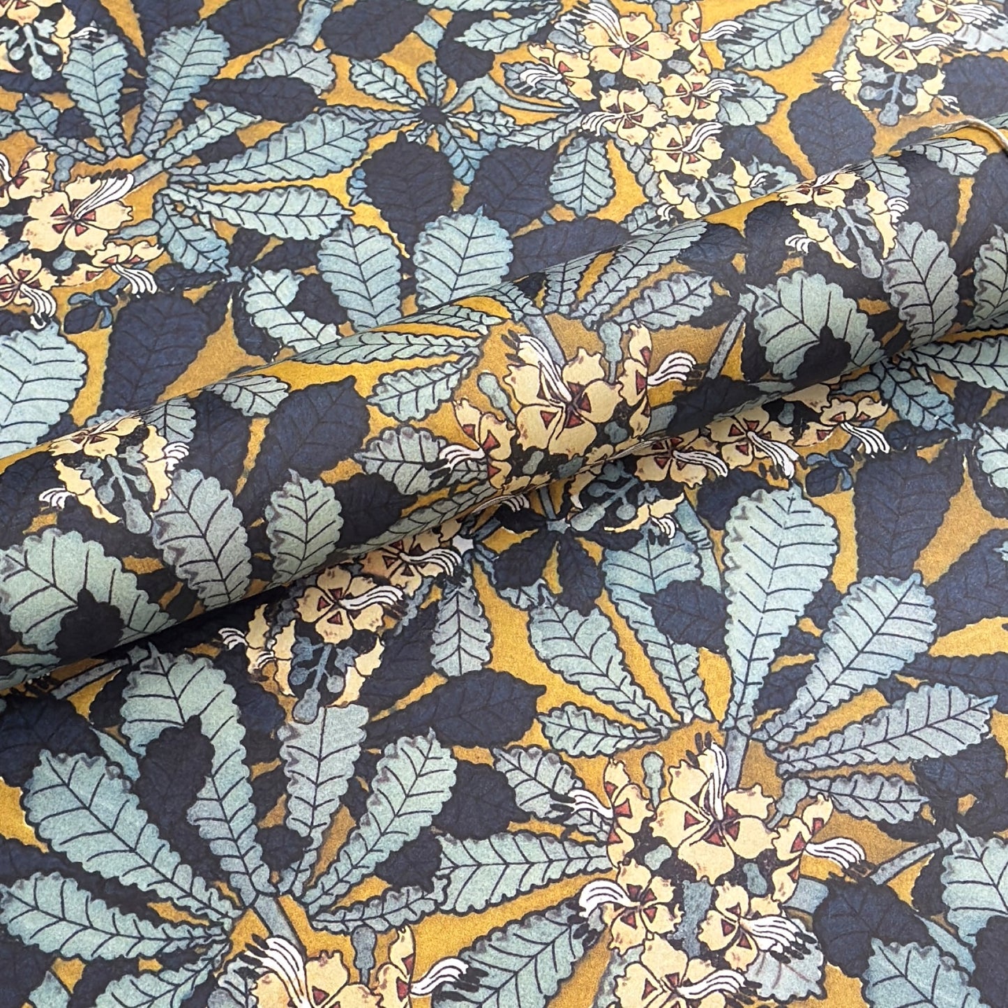 wrapping paper with a stylised design of sweet chestnut flowers in blue and yellow