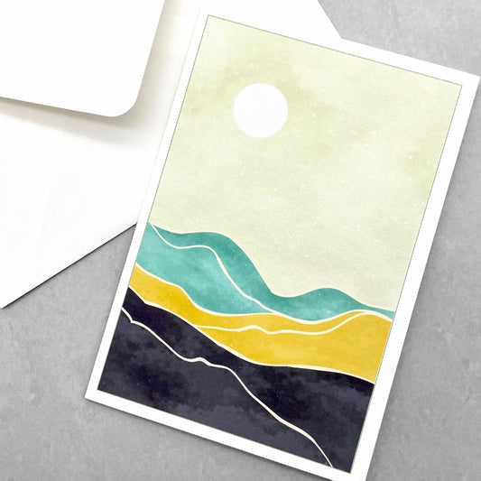 greetings card of a sun in the sky over a desert by Com Bossa Studio