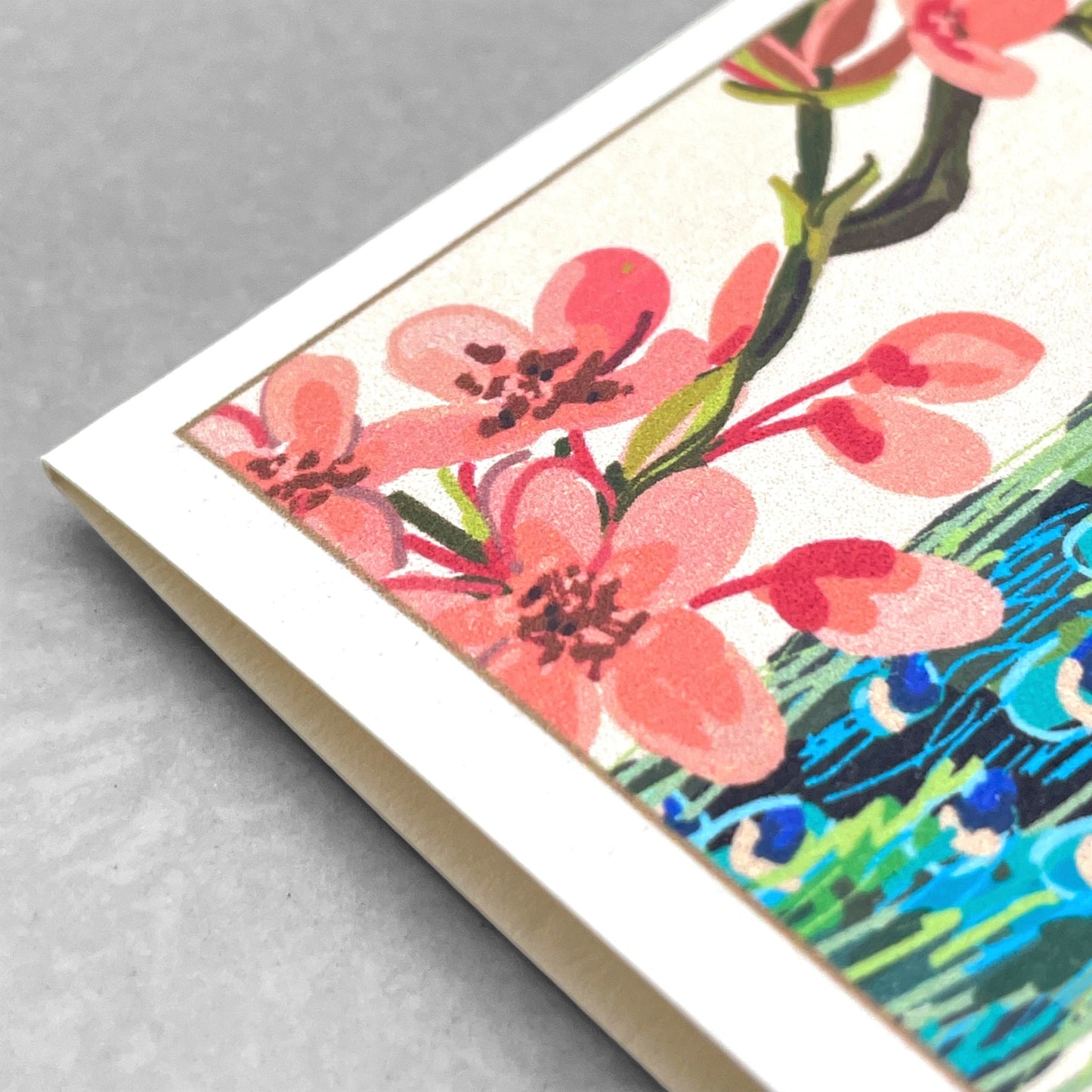 greetings card of a peacock on a branch of a tree in blossom by Com Bossa Studio