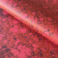 printed wrapping paper with a marbled stone pattern in deep reds and pinks by Compton Marbling