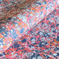 a printed marbled design wrapping paper in blue, orange and pink, by Compton Marbling