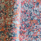 a printed marbled design wrapping paper in blue, orange and pink, by Compton Marbling