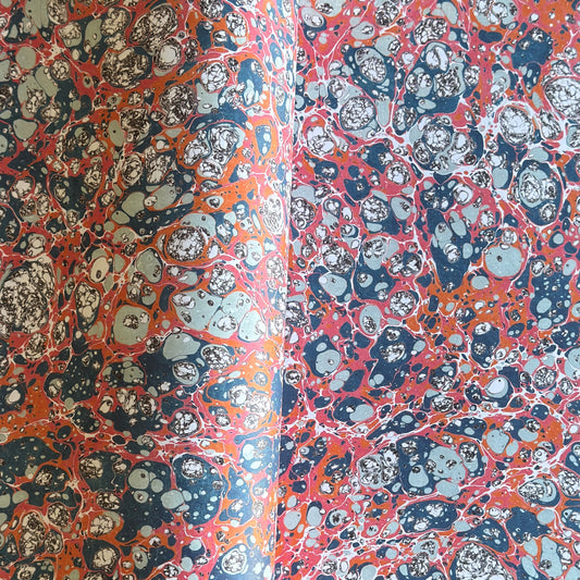a printed marbled design wrapping paper in blue, orange and pink, by Compton Marbling