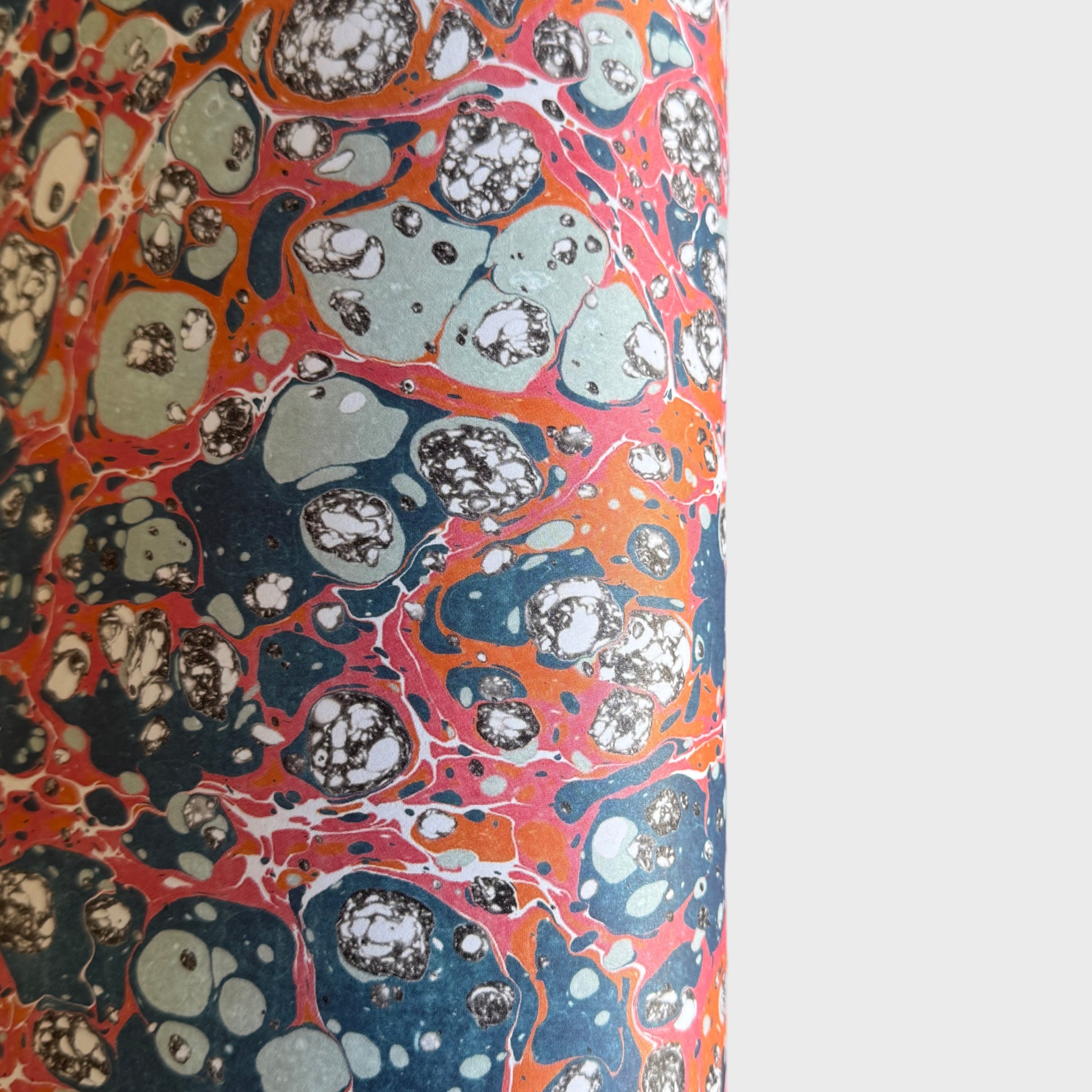 a printed marbled design wrapping paper in blue, orange and pink, by Compton Marbling