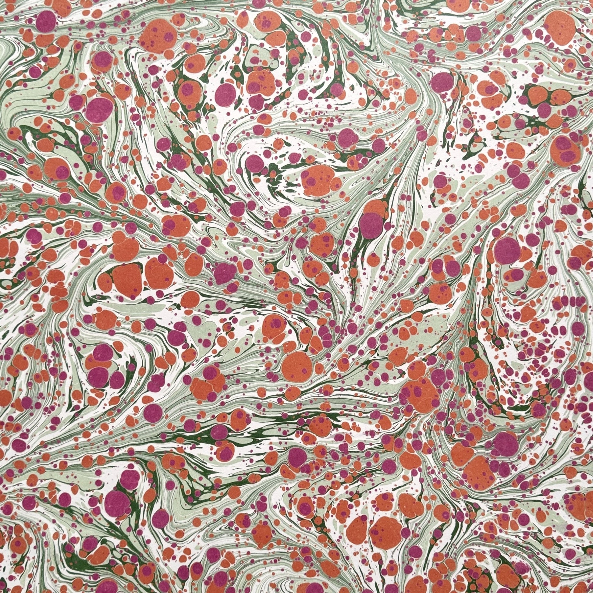 printed marbled design gift wrap with a marbled spot design in green, pink and orange.  By Compton Marbling