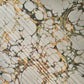 Printed marbled gift wrapping paper by Compton Marbling with a stone marbling pattern in soft grey, green and mustard.