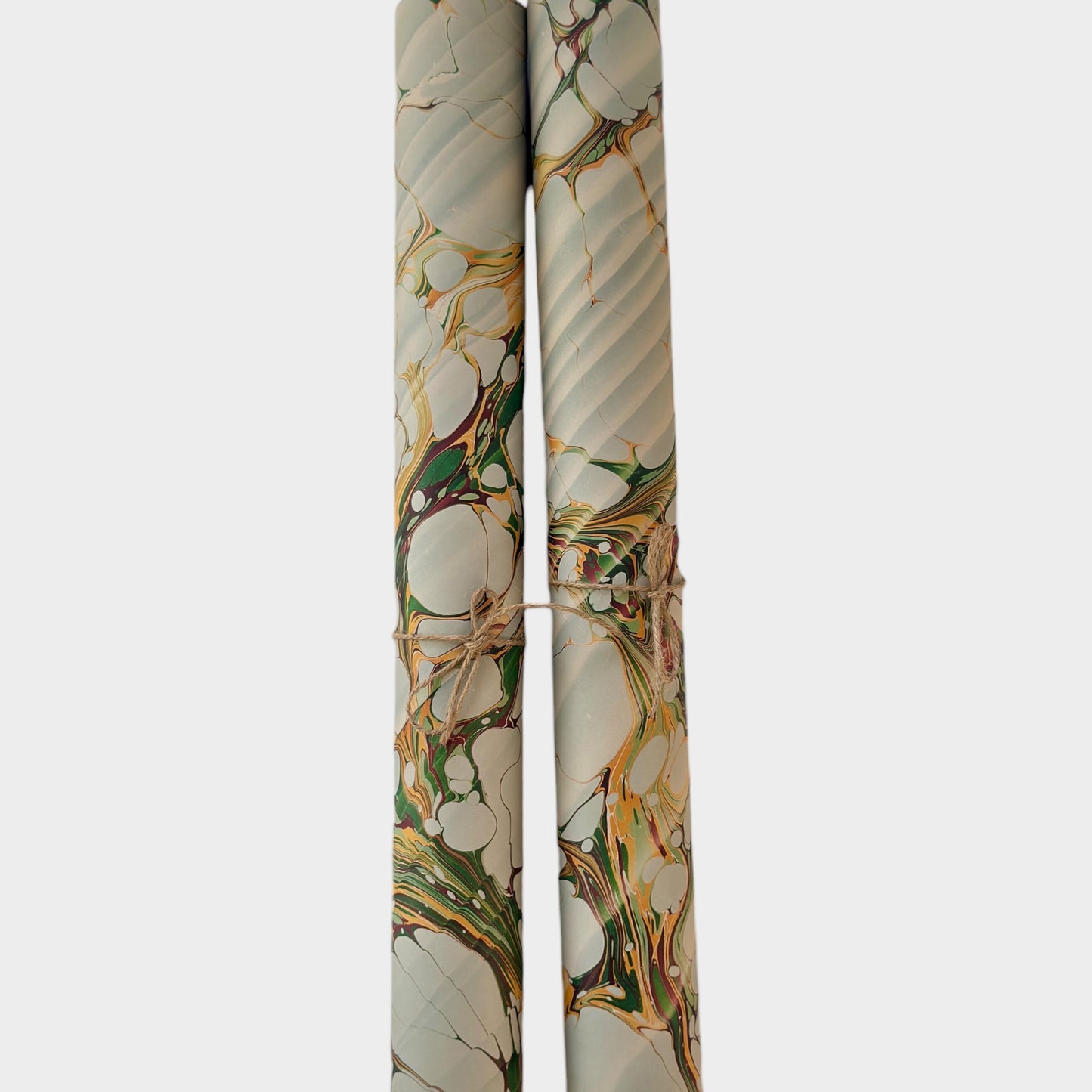 Printed marbled gift wrapping paper by Compton Marbling with a stone marbling pattern in soft grey, green and mustard.  Pictured rolled
