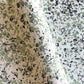 marbled printed wrapping paper with spot design in moss green, pale pink on a soft green.