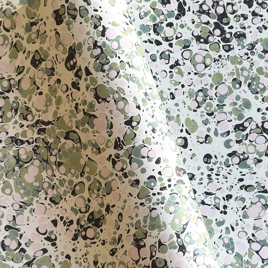 marbled printed wrapping paper with spot design in moss green, pale pink on a soft green.