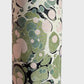 marbled printed wrapping paper with spot design in moss green, pale pink on a soft green. close up