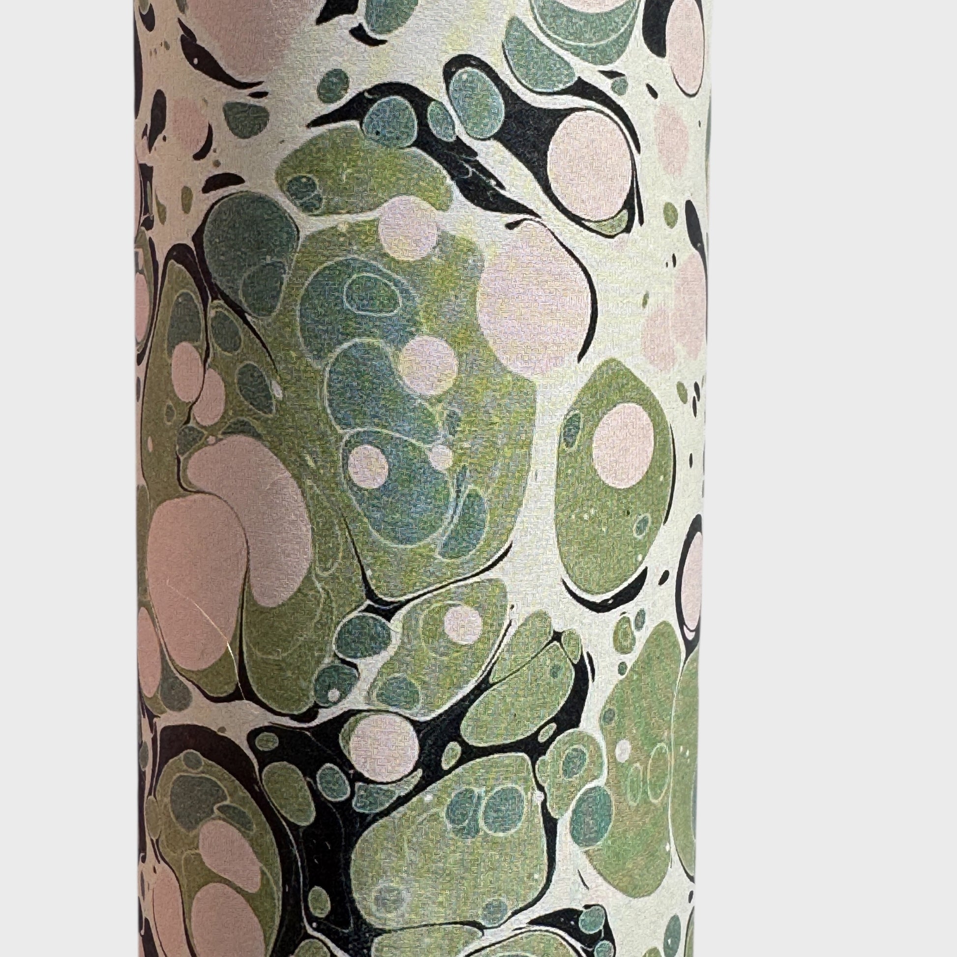 marbled printed wrapping paper with spot design in moss green, pale pink on a soft green. close up
