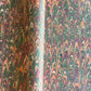 Printed marbled gift wrapping paper by Compton Marbling with a ripple marbled pattern in soft green, burgundy, cream and amber