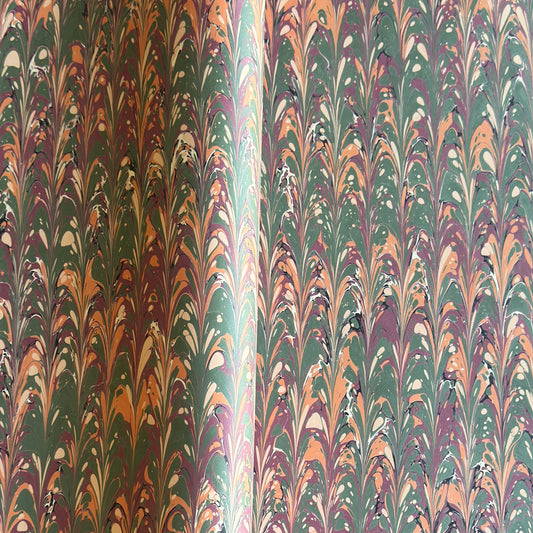 Printed marbled gift wrapping paper by Compton Marbling with a ripple marbled pattern in soft green, burgundy, cream and amber