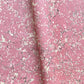 a sheet of wrapping paper with a pink marbled pattern with white and black veined design