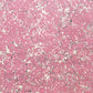 a sheet of wrapping paper with a pink marbled pattern with white and black veined design