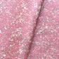 a sheet of wrapping paper with a pink marbled pattern with white and black veined design