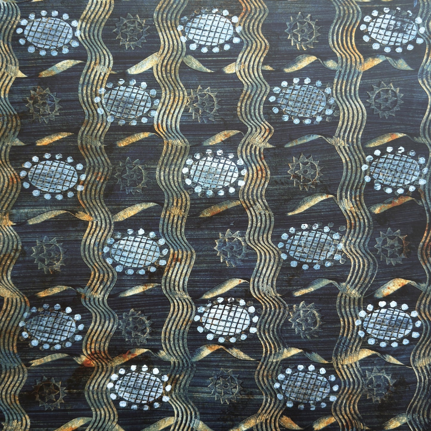  a sheet of wrapping paper with a relief printed star and flower in white on a inky blue paste paper backdrop
