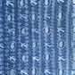 a sheet of wrapping paper with a relief printed oak leaf and bird in white on a blue paste paper backdrop