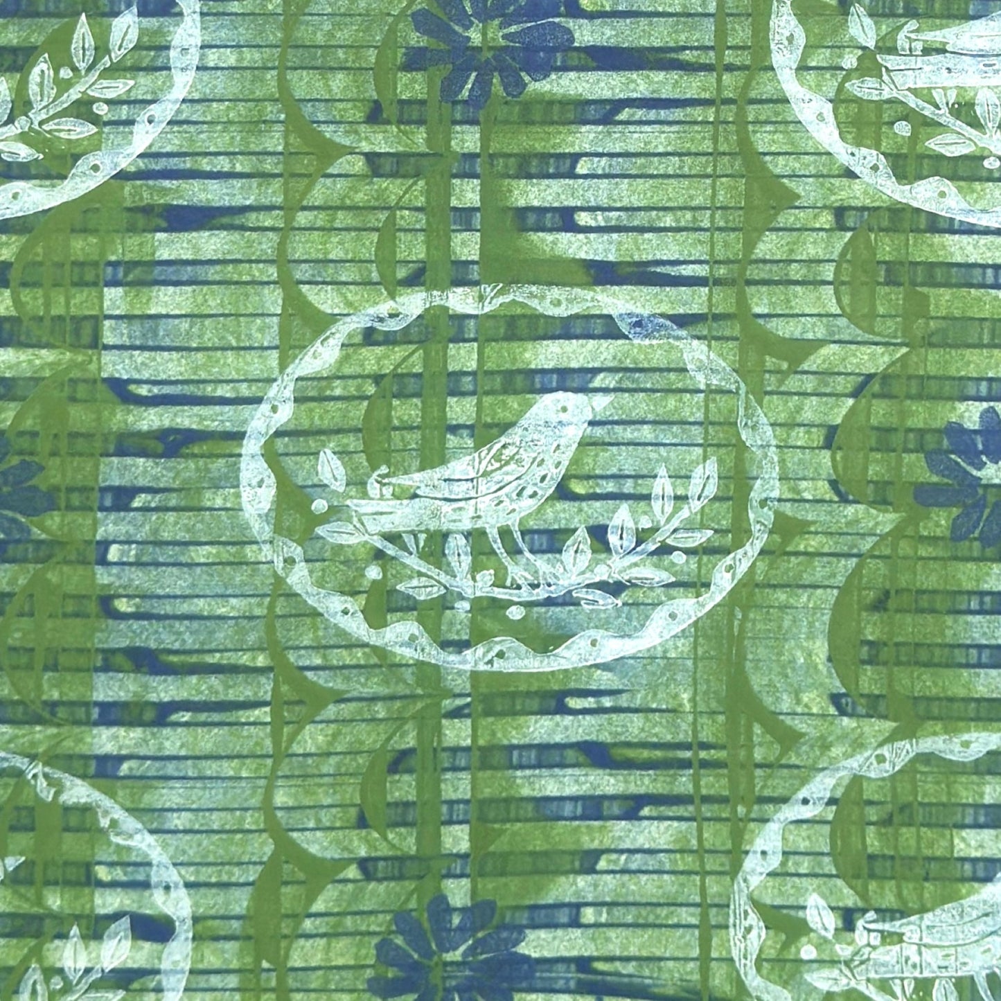 a sheet of wrapping paper from the Danby Press with a  backdrop of green paste paper design and circular stamped white bird motifs