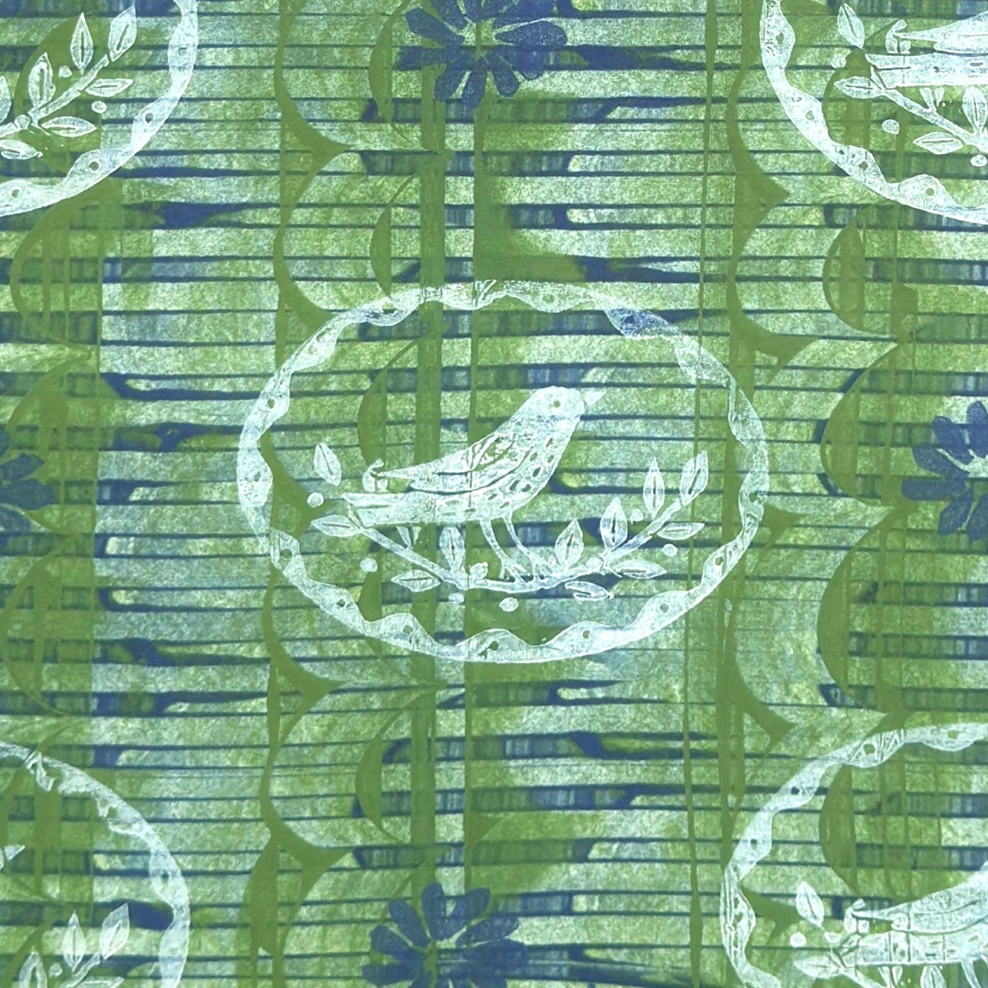 a sheet of wrapping paper from the Danby Press with a  backdrop of green paste paper design and circular stamped white bird motifs