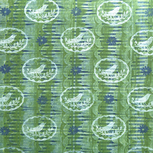 a sheet of wrapping paper from the Danby Press with a  backdrop of green paste paper design and circular stamped white bird motifs