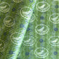 a sheet of wrapping paper from the Danby Press with a  backdrop of green paste paper design and circular stamped white bird motifs