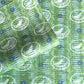 a sheet of wrapping paper from the Danby Press with a  backdrop of green paste paper design and circular stamped white bird motifs