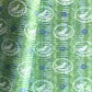 a sheet of wrapping paper from the Danby Press with a  backdrop of green paste paper design and circular stamped white bird motifs